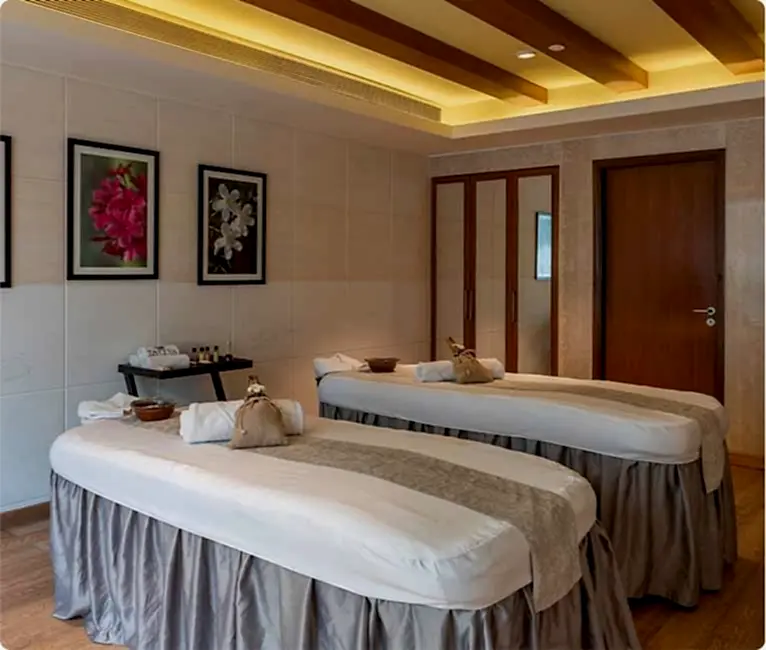 Tattva Spa couple spa room featuring two spa beds placed side by side, designed for a relaxing and rejuvenating couple massage experience.