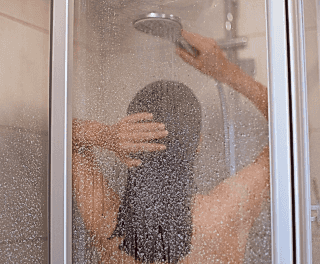 Guest taking a refreshing shower at Tattva Spa, ensuring cleanliness and relaxation before or after a wellness therapy.